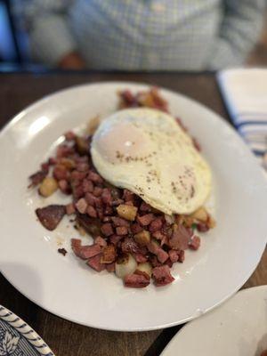 Homemade corned beef hash with hashbrown and over easy eggs