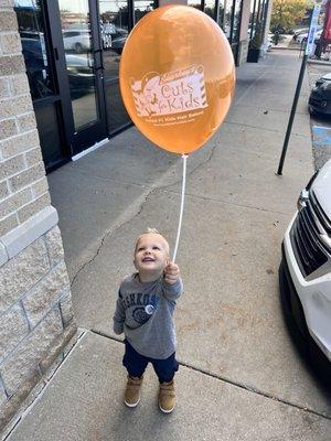 Recent haircut with our sticker and balloon