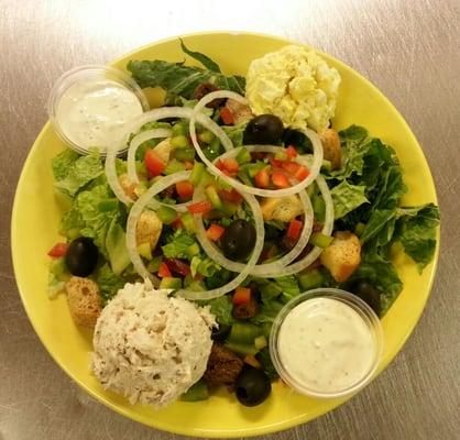 Garden salad with tuna and egg salad scoops.