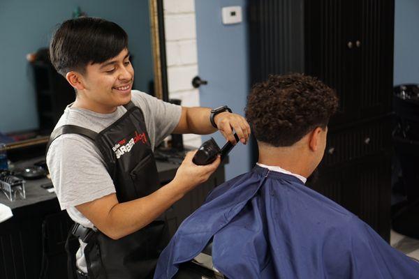 Polo the Barber servicing a client