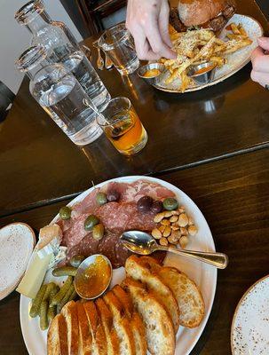 Charcuterie board, and Chicken Sandwich with Parmesan Garlic Fries.