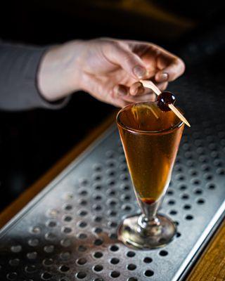 Bartenders making drinks behind the bar.