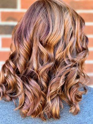 Beautiful natural red hair enhanced with tones of copper, mahogany, and vibrant red.