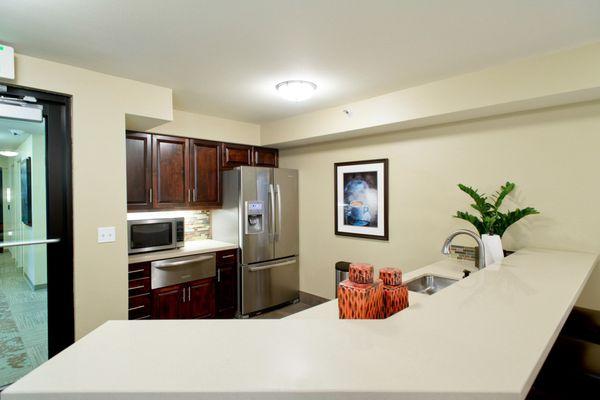 Resident lounge kitchen with stainless steel appliances.