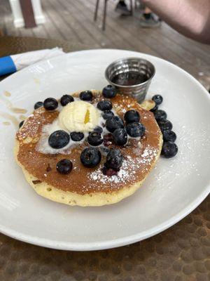 Photo of a stack of blueberry pancakes, which can come with the Breakfast of Champions meal.