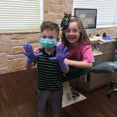 Brother is ready to help put on sister's braces!