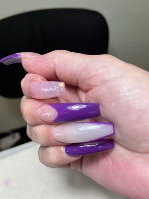 Sparkling on some purple on some long curve nails.