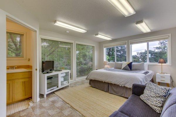 This bedroom is surrounded by stunning coastal views. Book your next Oregon Coast trip with Vacasa! vacasa.com/usa/Oregon-coast