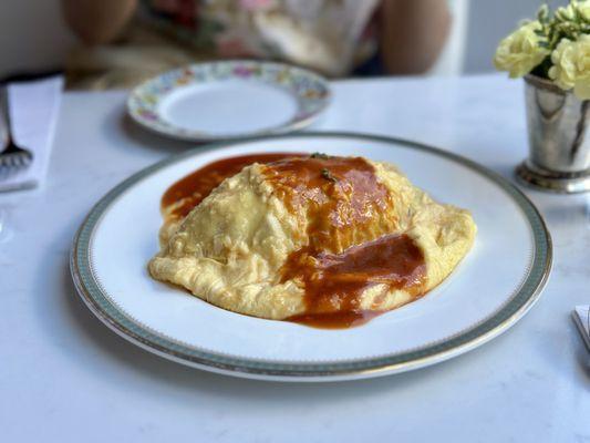 Rice Omelet - tender, scrambled eggs atop fried rice with bacon, onion, green peas, mushroom, scallop powder, with demi-glace sauce