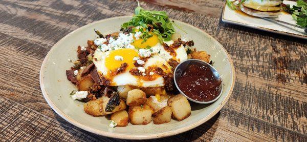 Honey Bacon Brussels Hash. Seasonal dish. Big plate. So delicious. Got my eggs Sunny up. Goat cheese, arugula, sweet marmalade on the side.