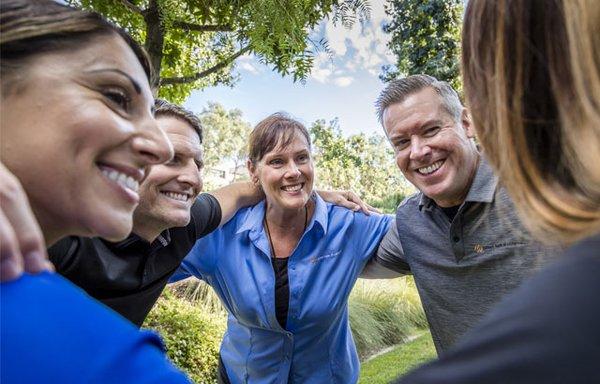 Partners Bank of California employees happily smiling at each other.