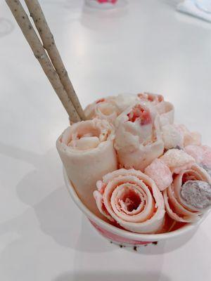 Vanilla rolls mixed with strawberry, topped with mochi and pepero