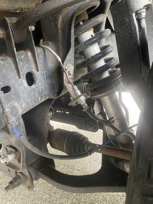 Brake line left hanging.