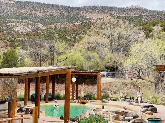 Outdoor hot spring pools with pavilions for shade