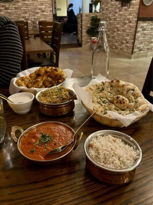 Lamb Biryani with Raita, Garlic Naan, Butter Chicken, and Chili Naan