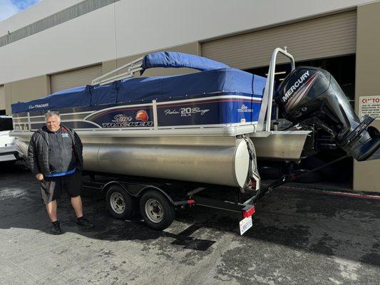 Owner Steve Gailey and a customer's new boat trailer tires.