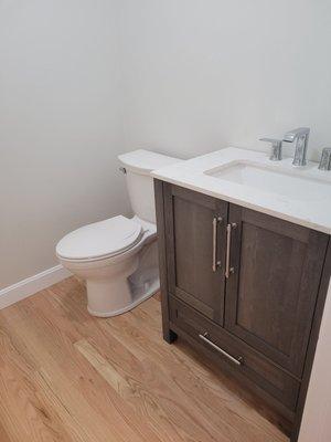 Downstairs powder room with red oak hardwood