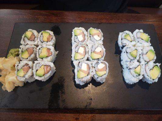 Assortment of sushi , left salmon avocado roll, Philadelphia roll and crab avocado roll