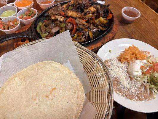 Home Made Corn Tortillas and fajitas side plate with salsas in background