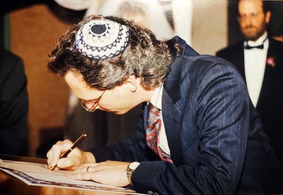 Rabbi Andrew Straus signs a Marriage License and Ketubah during a wedding ceremony at Temple Emanuel in May, 1999.