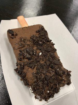 Chocolate dipped paleta covered in Oreos