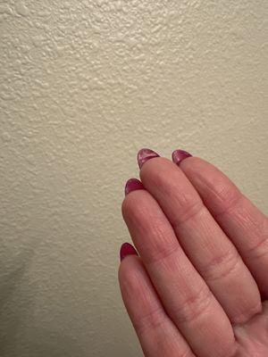 Acrylic left under nail that she said she would fix.