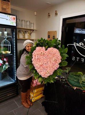 Heart made with pink carnations and pink roses.