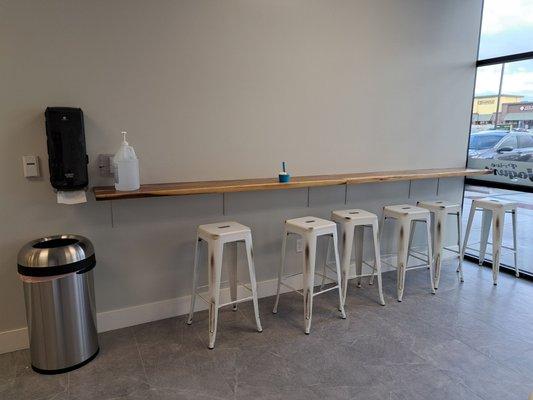 Bar stool seating inside the restaurant. Hand sanitizer available.