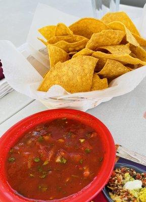 Warm crispy chips and fresh salsa. Salsa is fairly mild with chunks of tomato