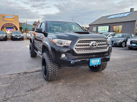 Lifted black Toyota Tacoma at Driven used car dealership in Boise, ID