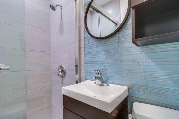 Our latest bathroom with custom seablue glass tile remodeled November 2020