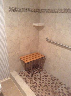 New tile shower with Moen grab bar and Freedom fold down bench