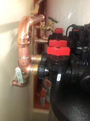 We hard-pipe our softeners using copper to ensure stability. We also provide two isolation valves and a soft water hose bib.