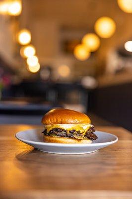 - Classic Smash Burger - 
 Black Hawks Farm Wagyu, American Cheese, Shaved White Onion, House Garlic Aioli, Pickle