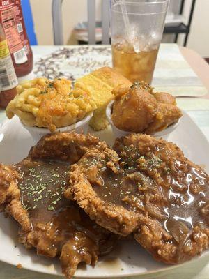 Smothered pork chops w/yams, Mac & cheese, cornbread, and sweet tea.