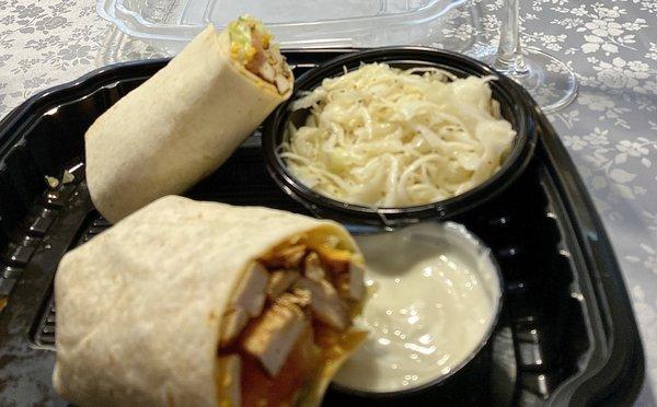 Buffalo chicken wrap with coleslaw on side.