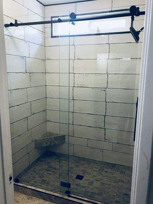 Top hung frameless sliding shower door