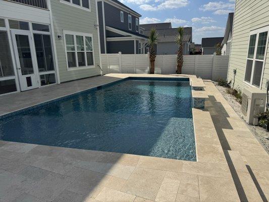 Pool with Ivory colored travertine decking.