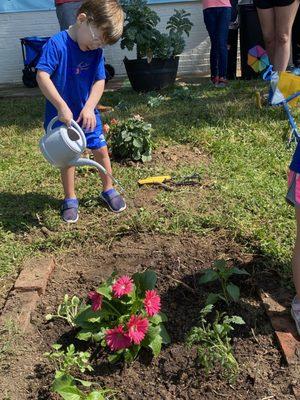 Stars students working on their family plot in our community garden