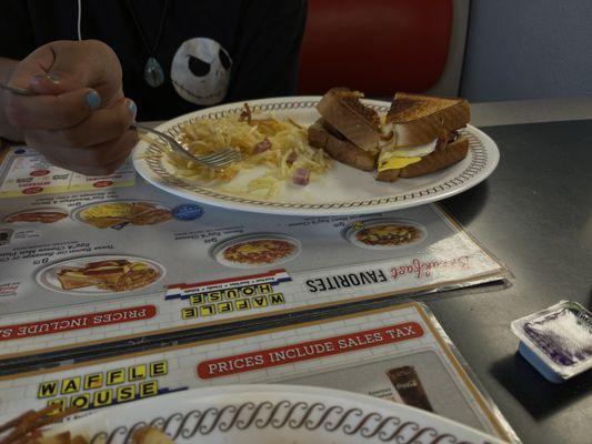 Scrambled eggs with cheese, beautifully cooked hash browns and toast.