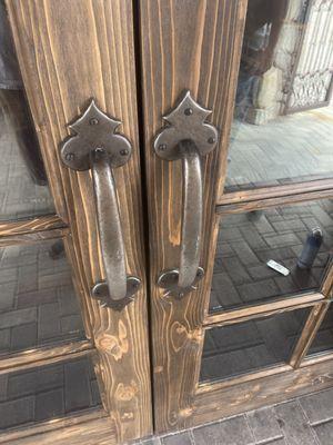 Up close view of hardware and knotty cedar doors.