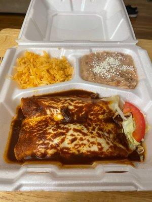 Enchiladas combo. Those are two corn tortillas, for size. Tiny slice of tomato and super small pinch of lettuce.