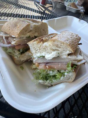 Turkey, cream cheese, onion, lettuce, tomato on a sourdough roll