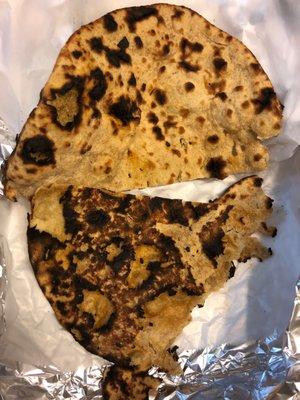 two pieces of burnt naan