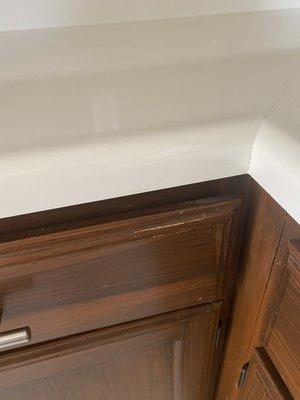 Chipped cabinets, covered in brown paint to "fix"