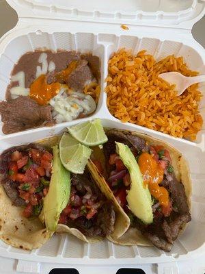 Steak tacos with rice and beans.