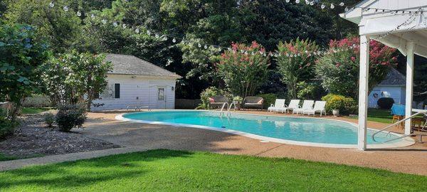 The beautiful backyard with a pool, yard games and a fire pit for smores!