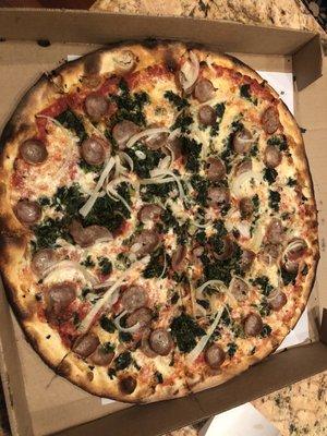 Spinach, onion and sausage pizza.