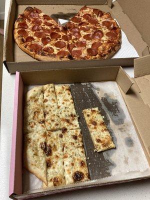 Delicious bread sticks, and large pepperoni pie.