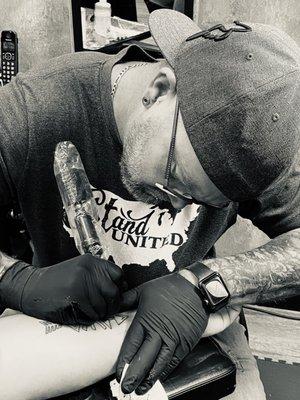 Anthony doing Tattoo work